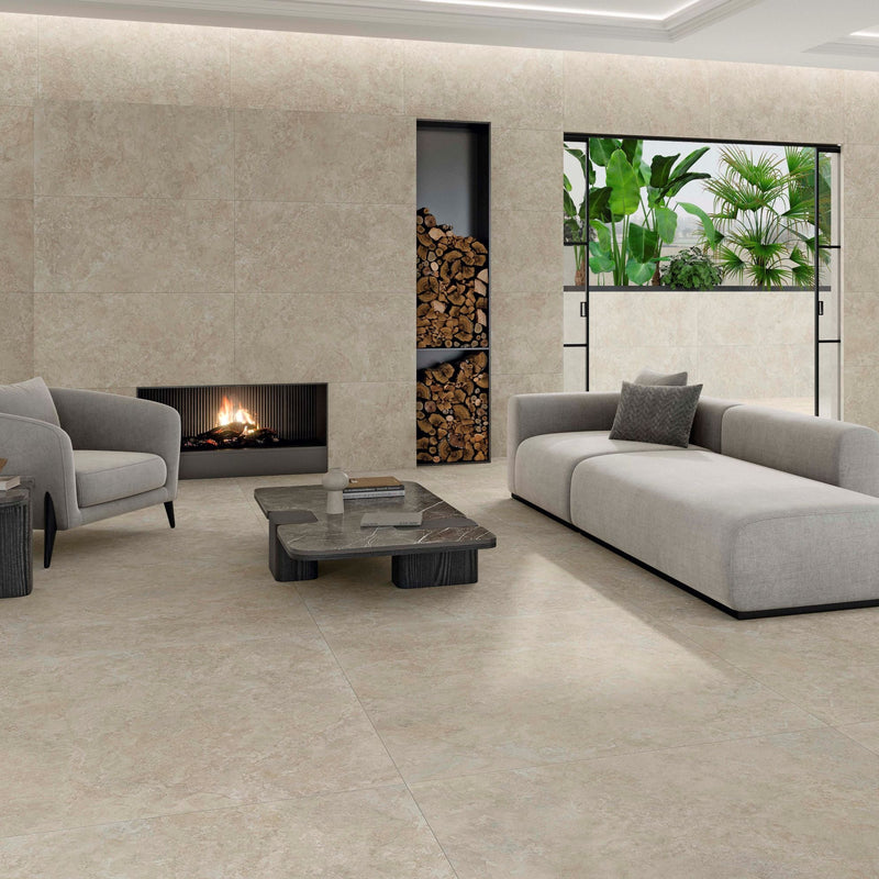 Premiere Natural cream beige stone effect porcelain tiles in a contemporary living room with subtle mottled detailing and a matt finish.